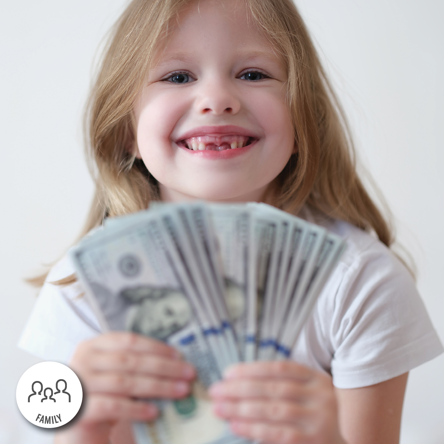 A smiling child holds a large amount of one hundred dollar bills.